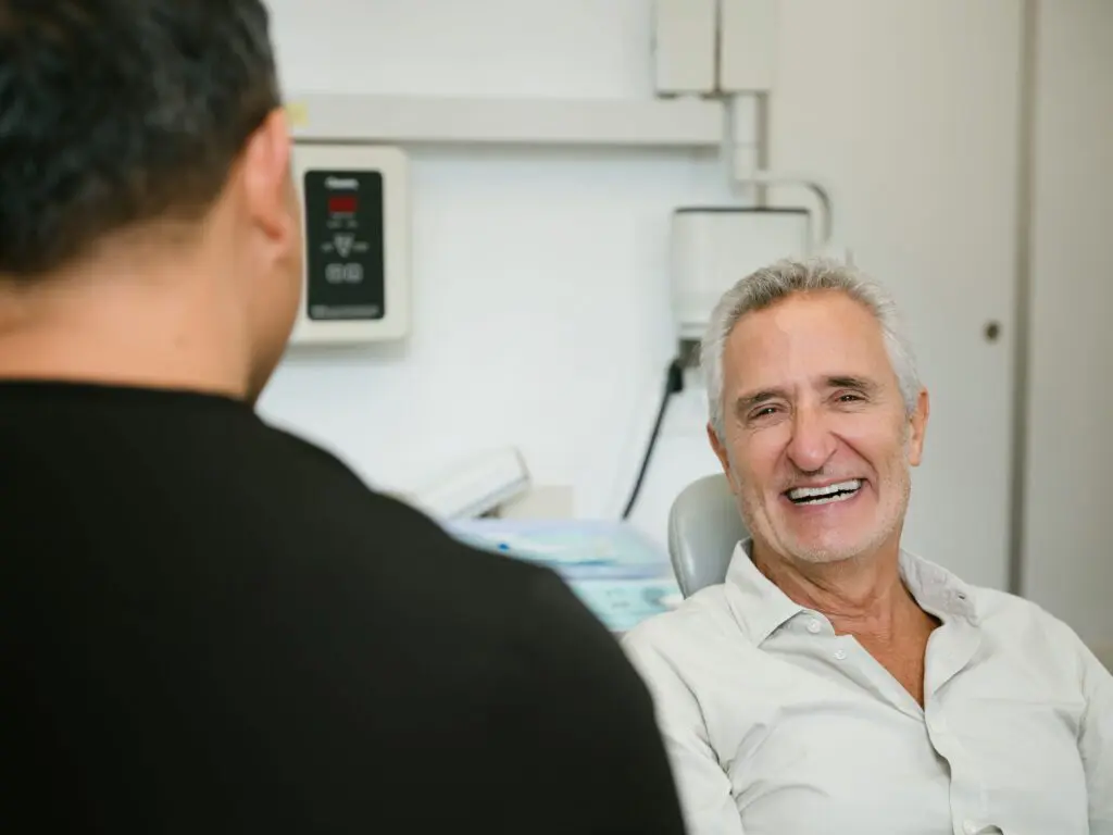 a man smiling at another man