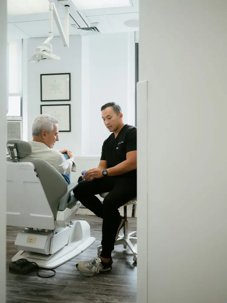 a man sitting in a chair with a doctor in his hand