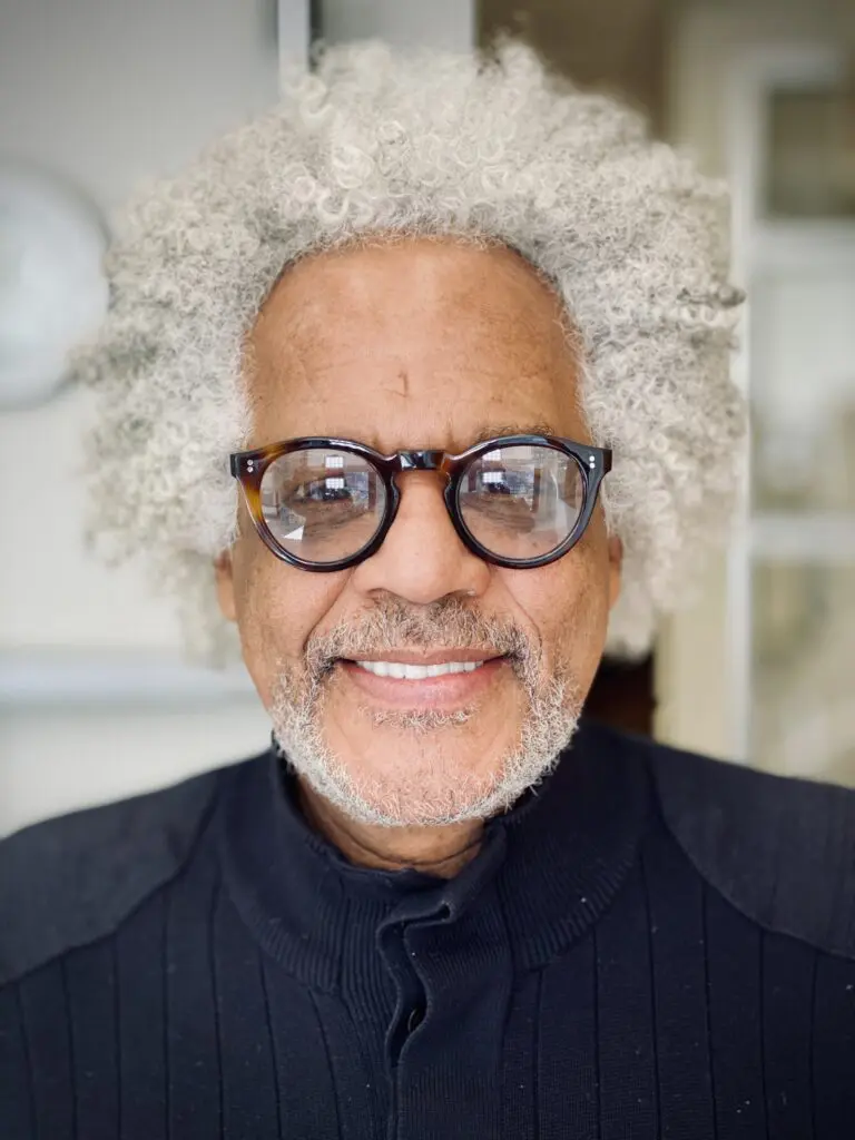 a man with white hair and glasses