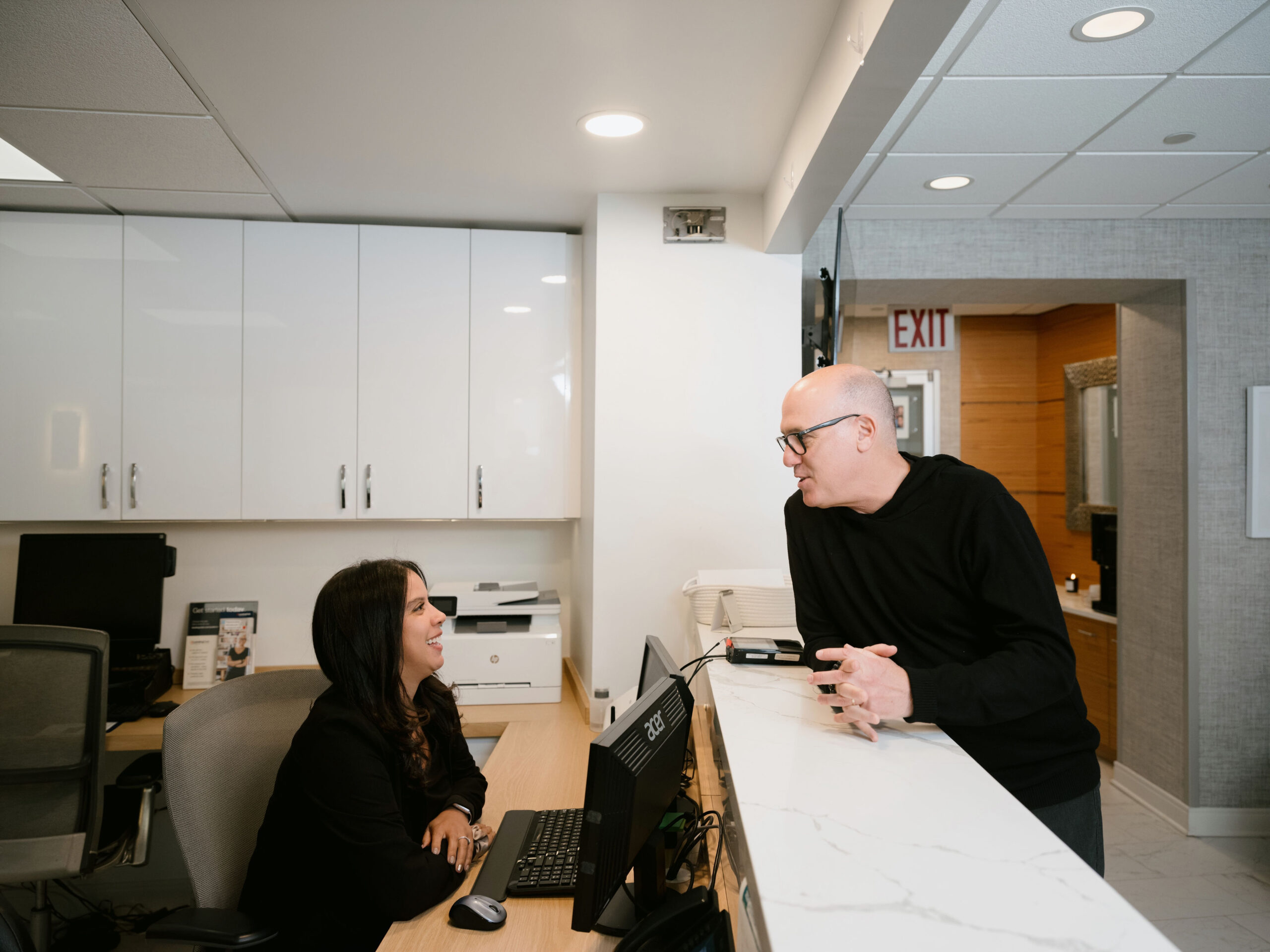 a man and woman sitting at a desk