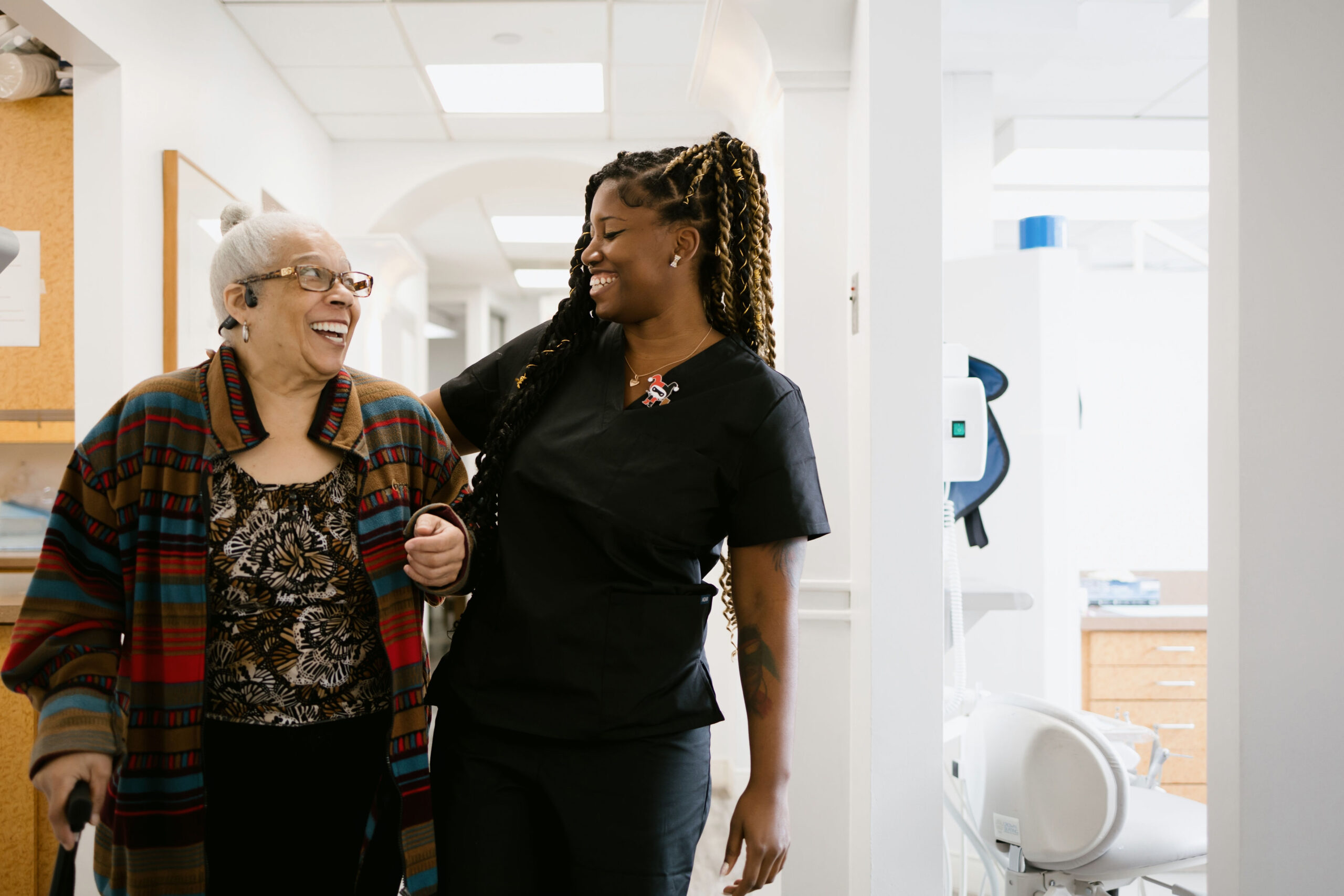 a woman in a black uniform and a woman in a hospital
